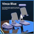 Folding portable desktop stand for mobile phones and tablets with a weighted base in multiple colours.