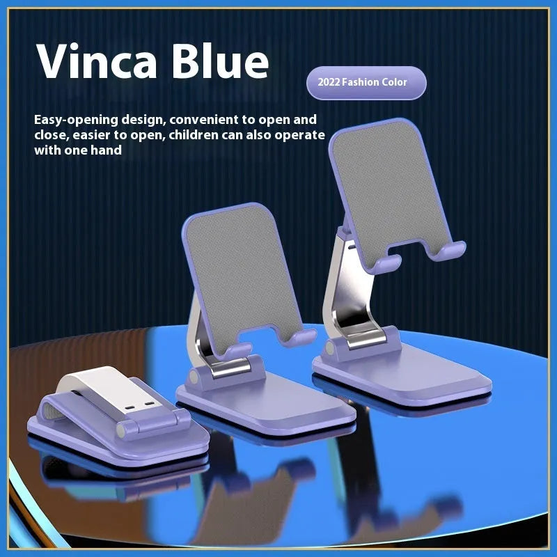 Folding portable desktop stand for mobile phones and tablets with a weighted base in multiple colours.