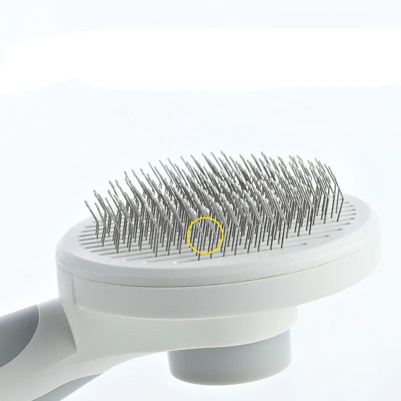 Round handle pet pass-through comb with stainless steel needles and self-cleaning button in pink colour