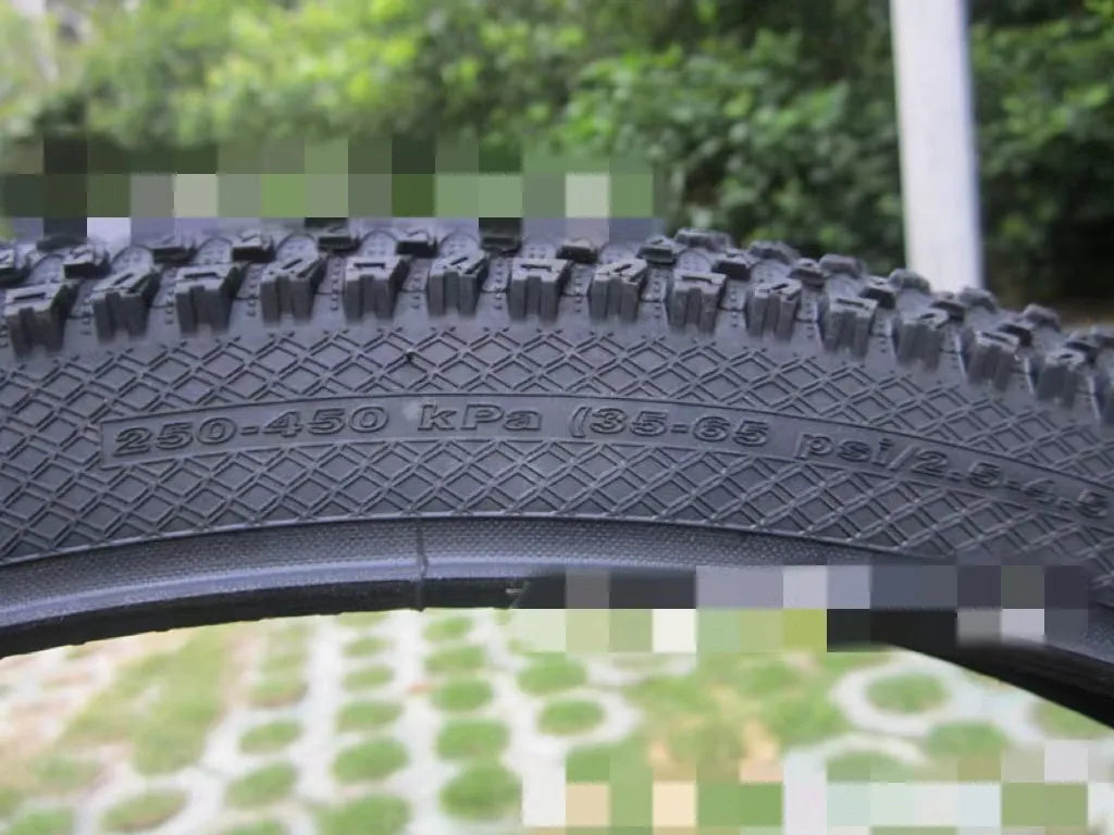 A mountain bike tyre showing tread pattern, with options for 26, 27.5, and 29-inch wheel sizes.