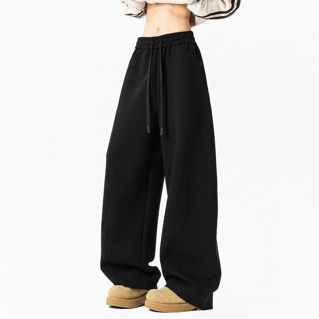 Men's relaxed dark grey or black trousers with drawstring waist, slight stretch, and included belt