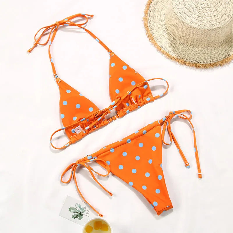 Women's polka dot and floral print split swimsuit bikini set on a mannequin.