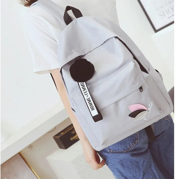 Canvas college backpack with leaf pattern in green colour showing front compartment and straps