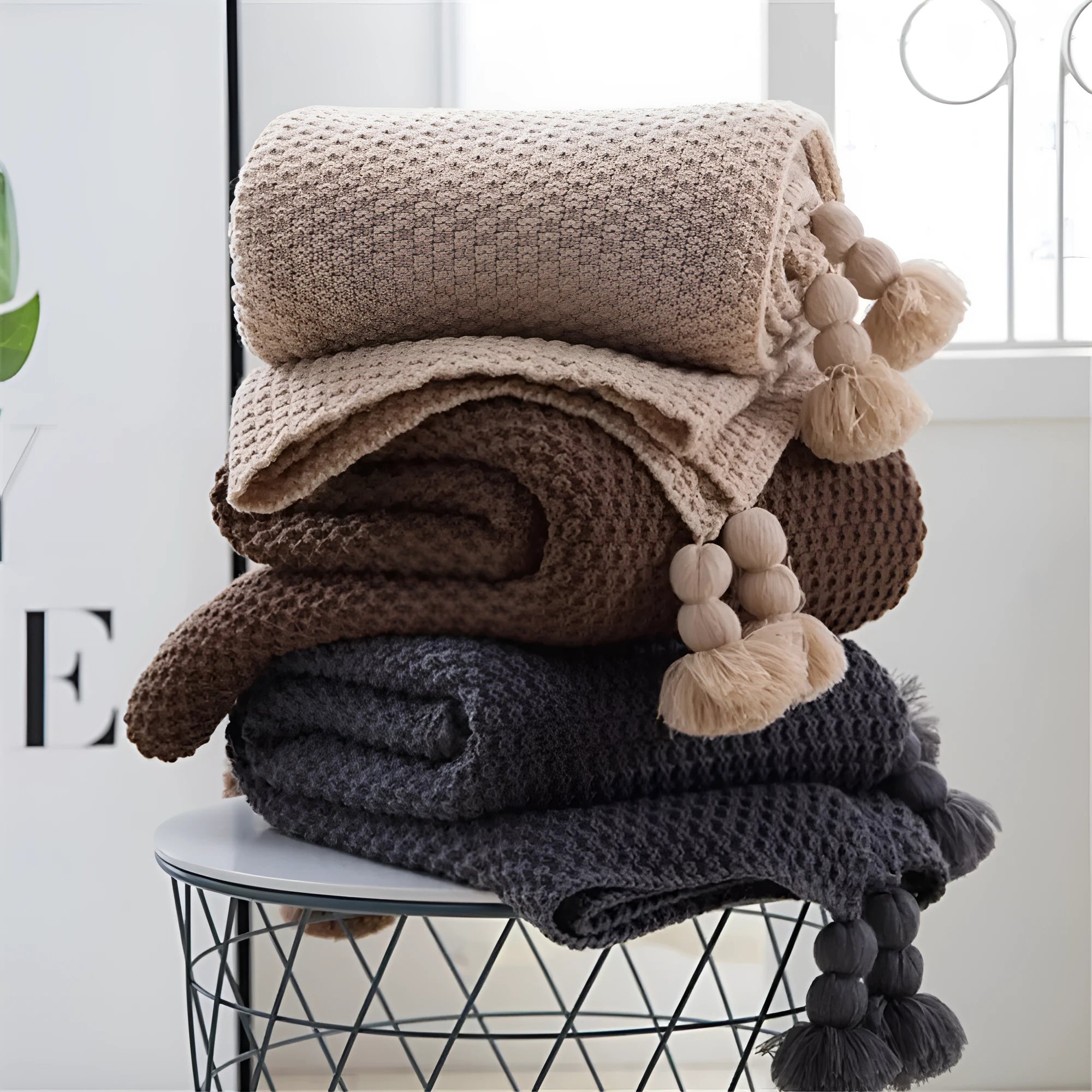 Nordic-style fringed knit acrylic blanket in beige, measuring 130 by 170 centimetres.