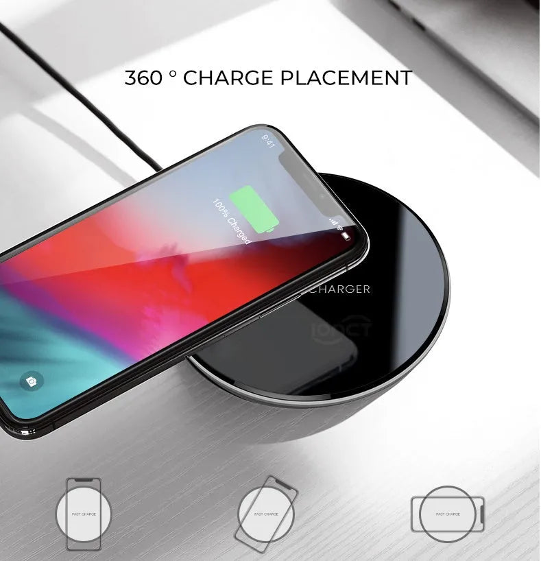 Black QI wireless charging pad on a desk, showing its non-slip silicone base.