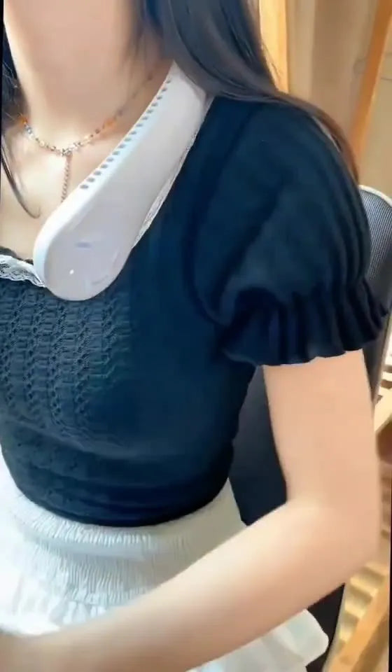 Pink bladeless neck fan being worn, showing adjustable neckband and air outlet.