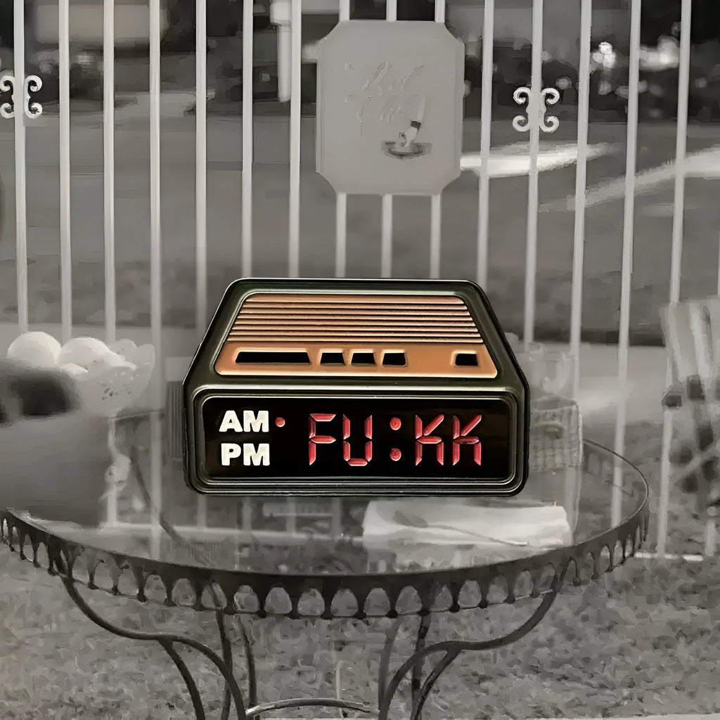 Black metal retro electronic alarm clock brooch pin with original design on a jacket lapel