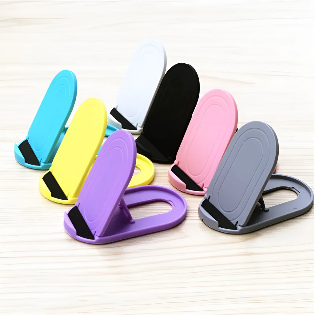 Plastic lazy bracket mobile phone stand in one of six colour options on a desk