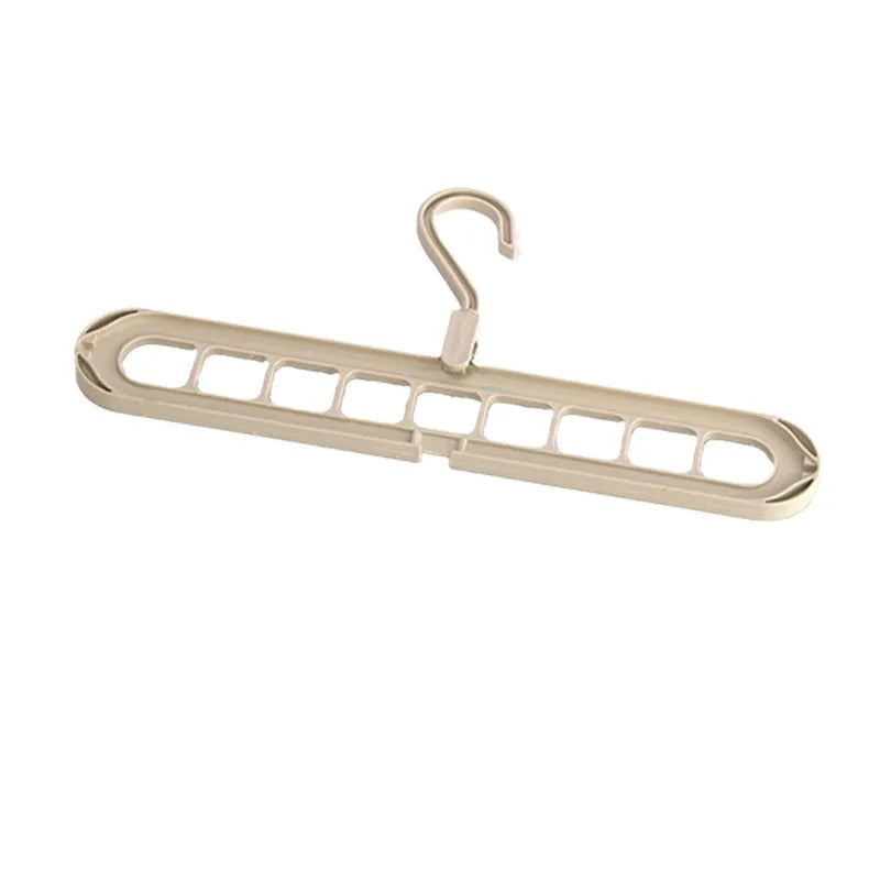 Green nine-hole plastic folding hanger with trousers organised vertically