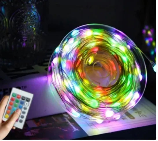 Multi-colour LED animated outdoor Christmas tree lights wrapped around a garden tree branch.