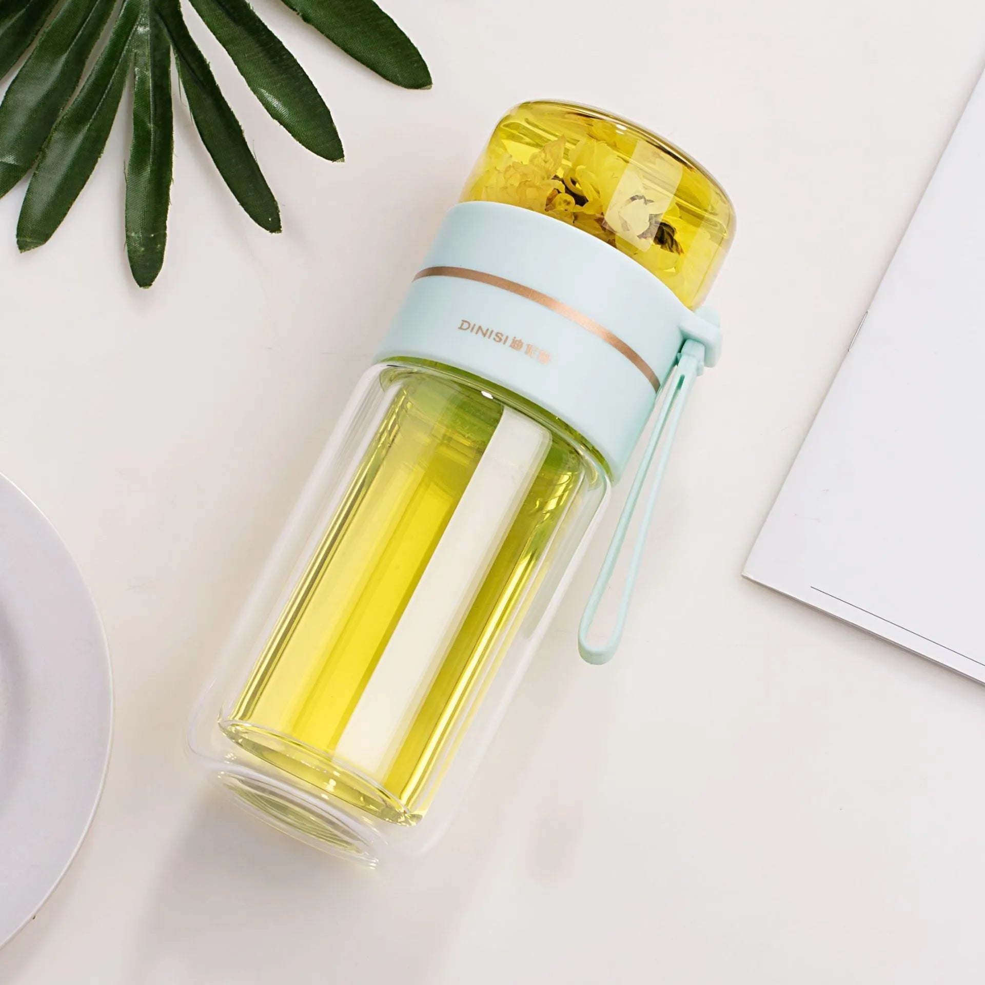 Glass water bottle with tea infuser filter showing double wall construction and portable rope