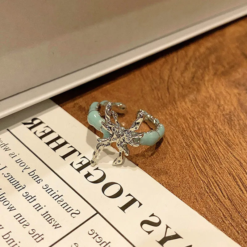 Copper butterfly women's ring with dripping oil texture and an open loop design.