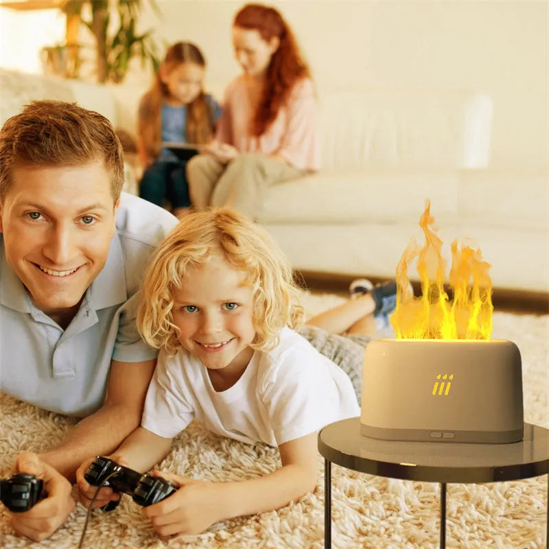 Black round ultrasonic humidifier and aroma diffuser with flame effect LED lights on a table.