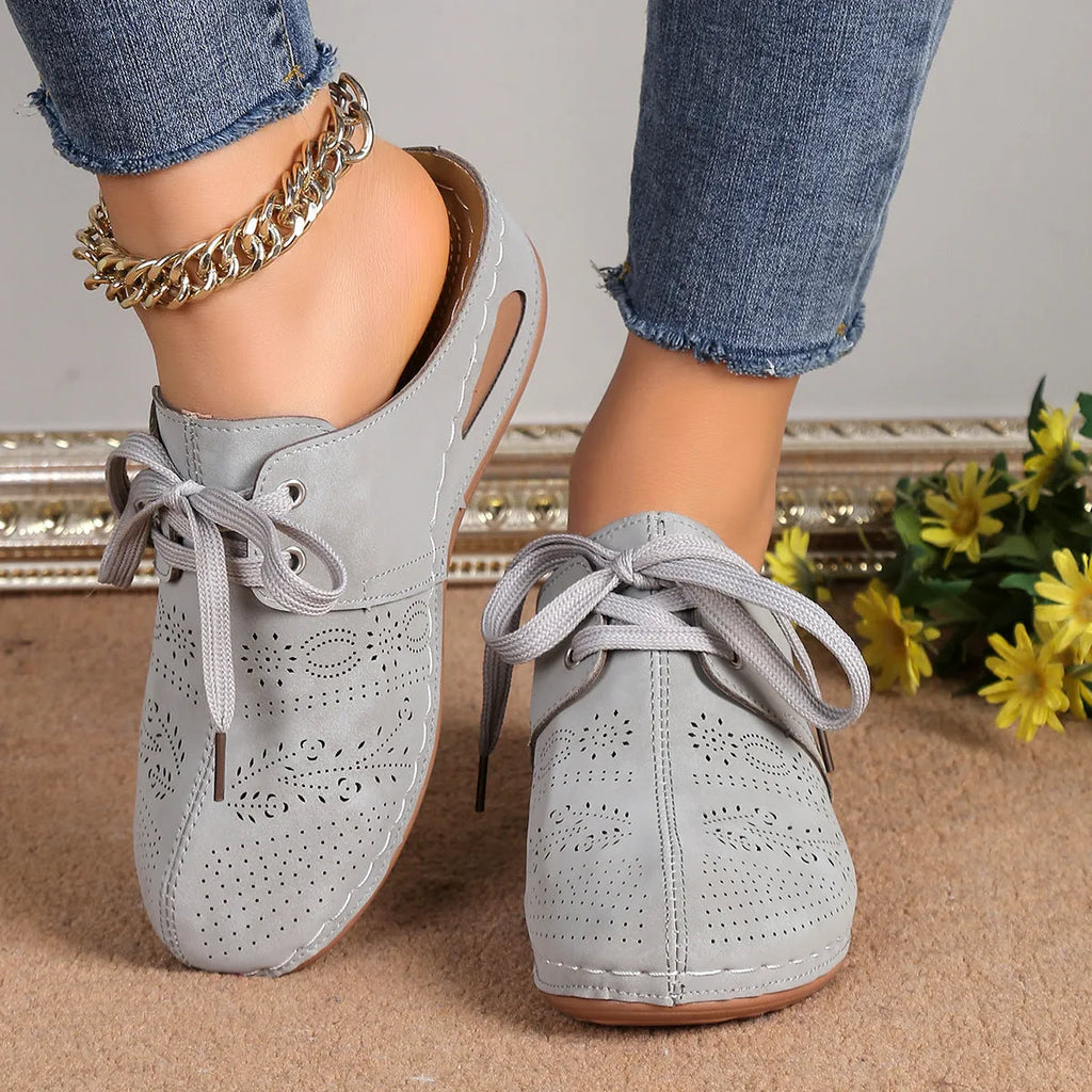 Women's black suede lace-up wedge sandals with a hollow-out design and rubber sole.