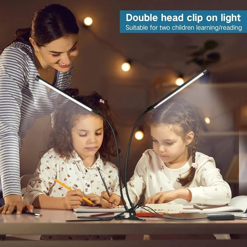 Black and white USB-powered LED desk lamp with a 26 cm long base on a wooden desk.