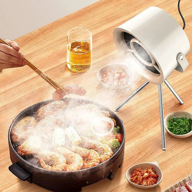 Milky white portable USB desktop exhaust fan with tripod stand and removable filter screen.