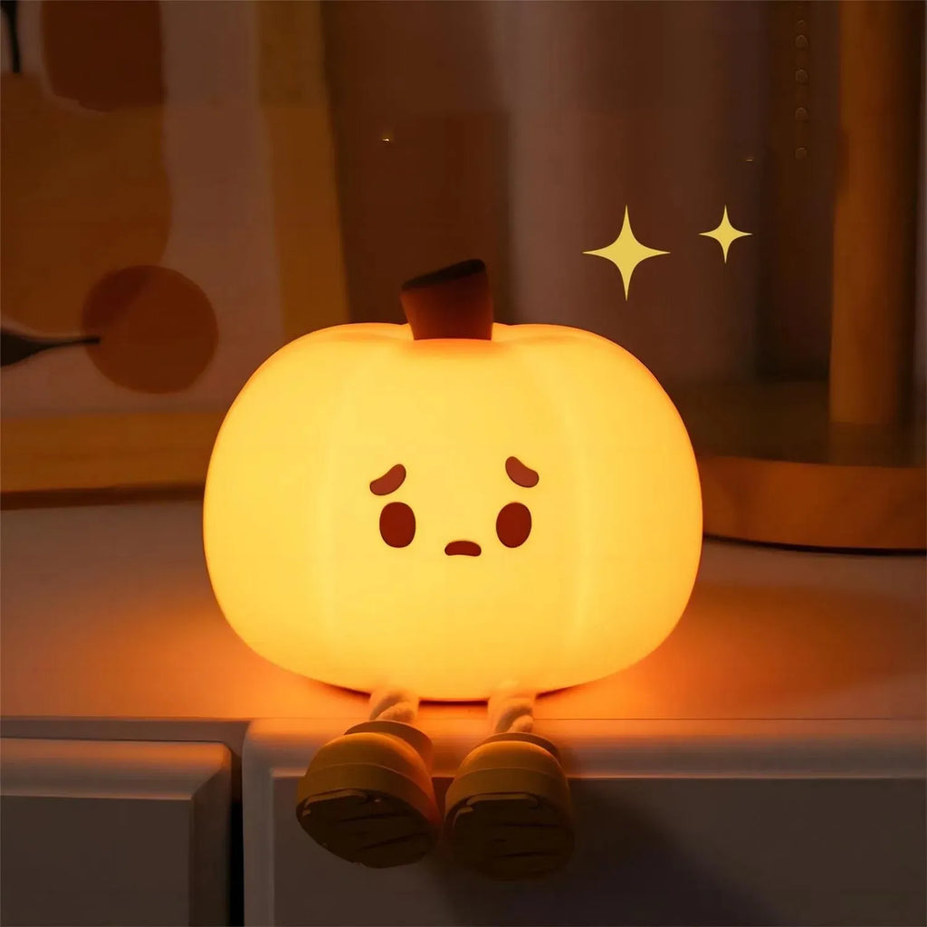 Soft silicone pumpkin night light with touch dimming controls and USB charging port