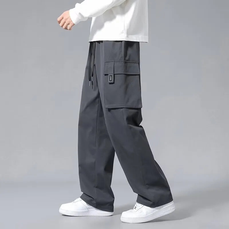 Boys' straight-leg cargo pants in army green with large pockets and a drawstring waistband.