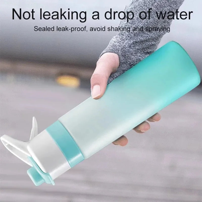 White plastic spray water bottle with handle strap and leakproof lid on a gym bag.