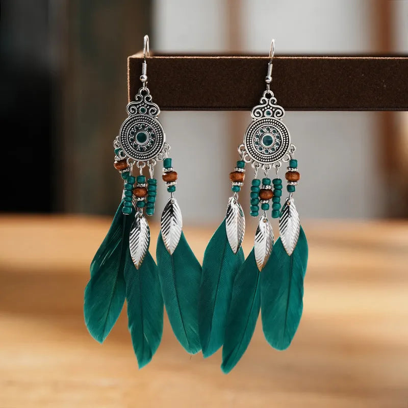 Round drop feather earrings in alloy with electroplated finish showing leaf shape and pattern details