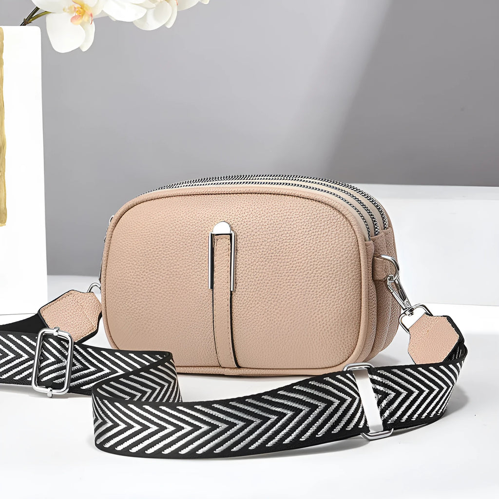 PU leather crossbody shoulder bag in oval shape with multiple internal compartments