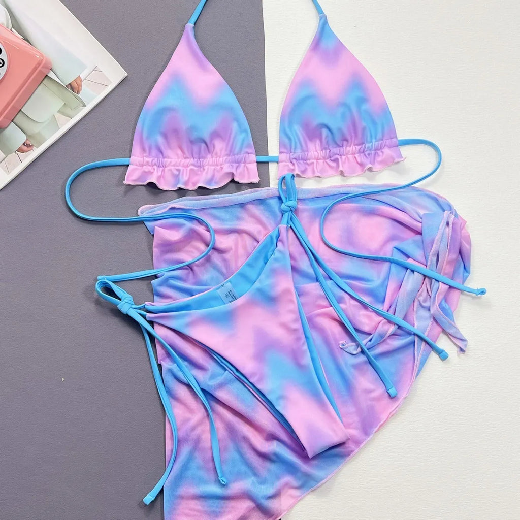 Women's split tie-dye bikini swimsuit set with matching skirt on mannequin