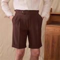 Man wearing Italian-style straight leg Neapolitan Kilge shorts in apricot colour.