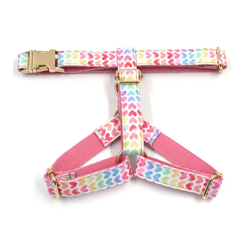 Pink dog harness with gold buckle and colourful heart-shaped stone decoration in four sizes