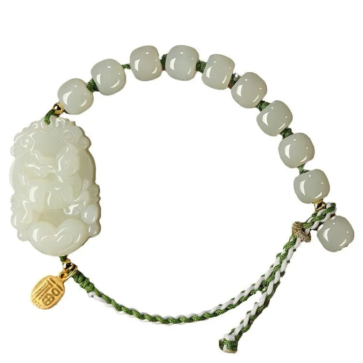 Red rope bracelet with a carved green Hetian jade Rabbit charm and a small S925 silver card on a cotton cord.