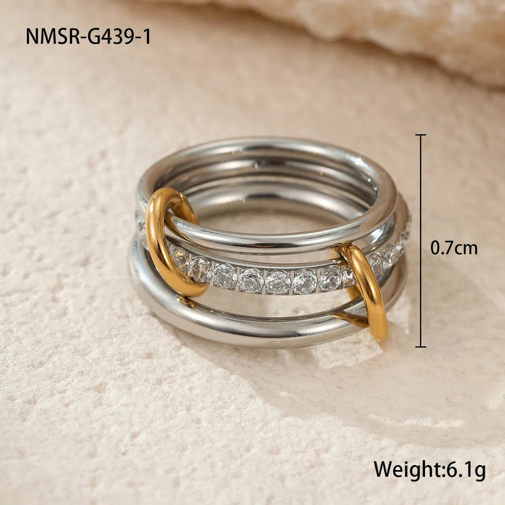 Stacked colour matching stainless steel ring with 18K gold plating on a hand.