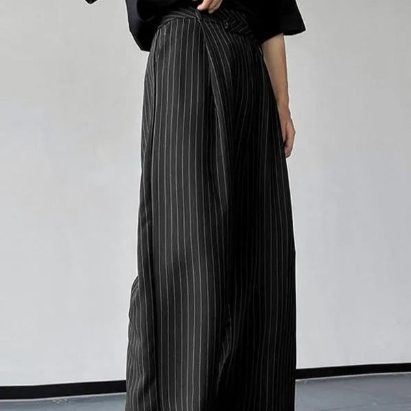 Black men's casual trousers with vertical stripes and front pleats on a hanger.