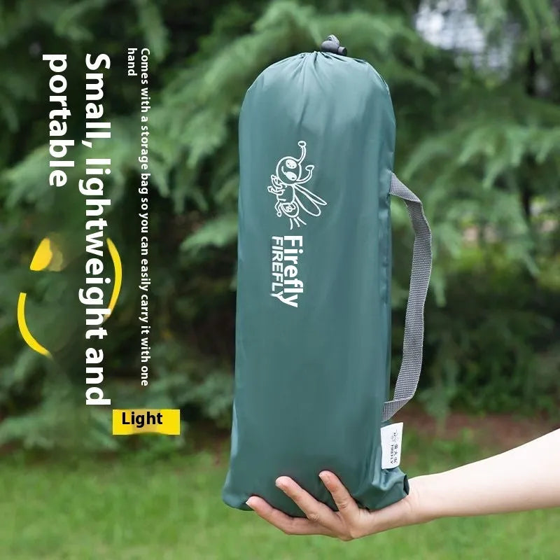 Single person portable camping tent in green, shown unfolded with fibreglass pole.