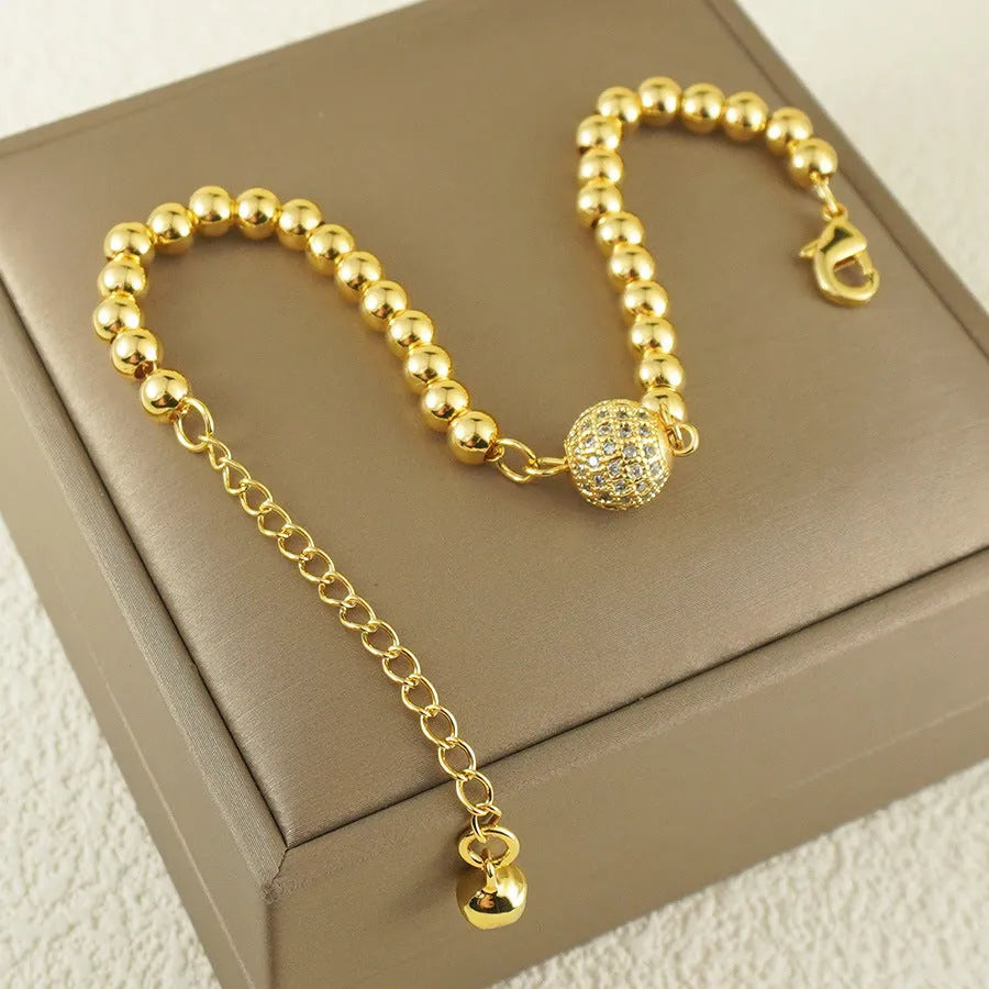 Close-up of a women's heart-shaped copper bracelet with a single round zircon stone, Arabic style.