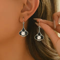 A pair of silver retro fashion creative earrings for women on a white background.