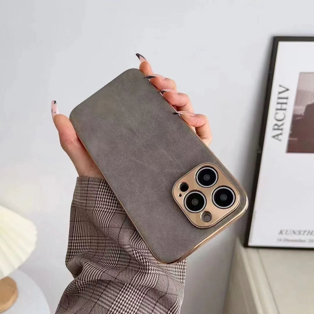 Leather texture TPU phone case for iPhone on a table, showing grey-green colour and precise camera cutouts.