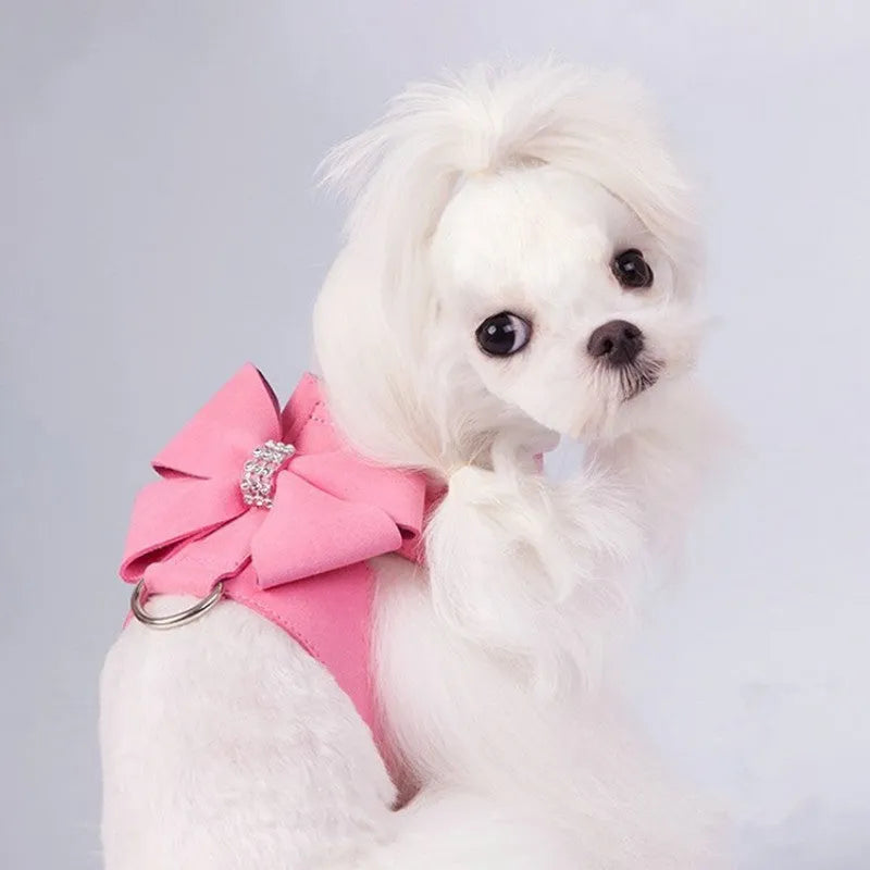 A cute pink microfiber puppy chest strap with a bowknot, showing the adjustable design.