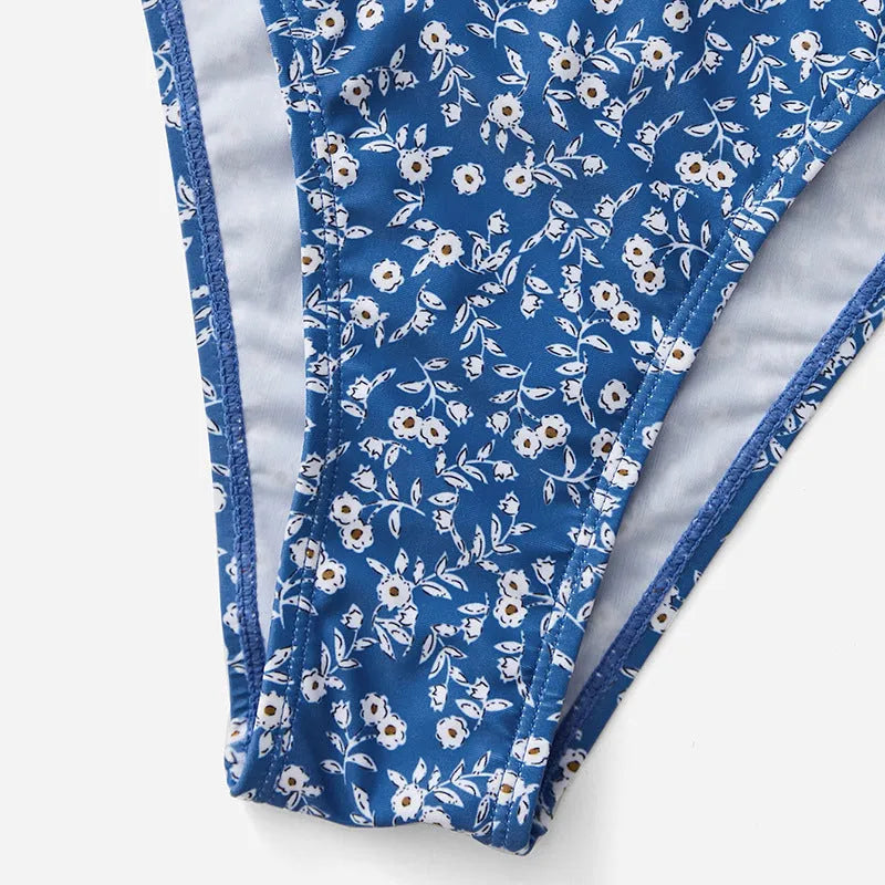 Blue women's swimsuit set with matching top and shorts on a white background.