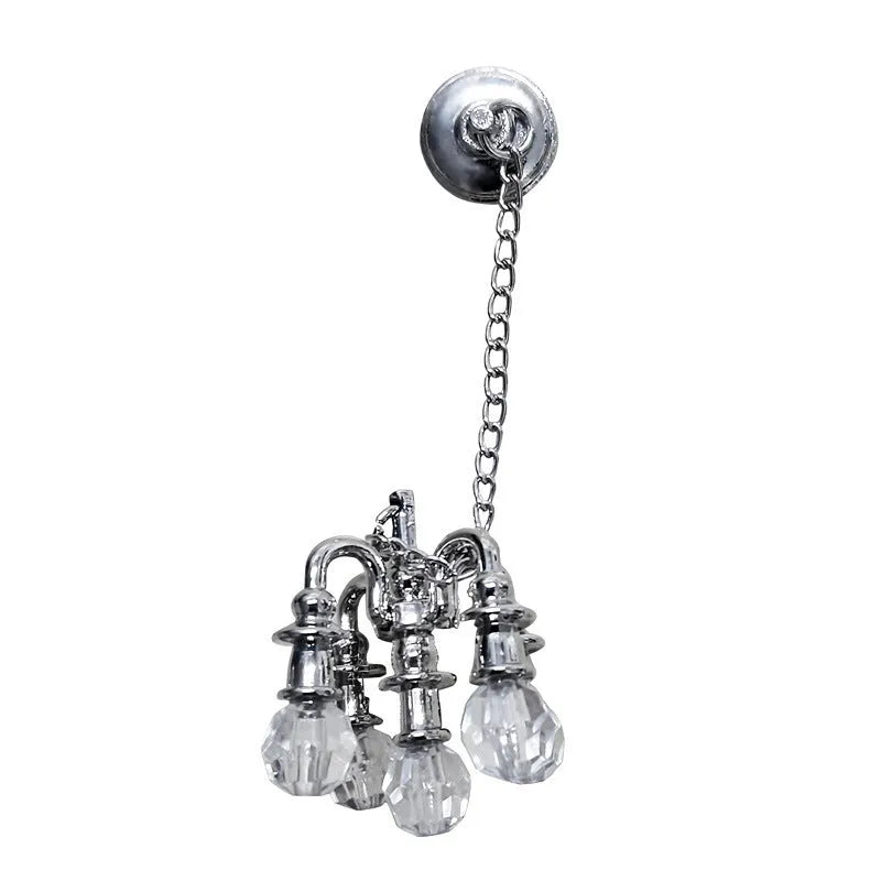 A small gold or silver metal photo prop decoration measuring 5 by 2 centimetres.