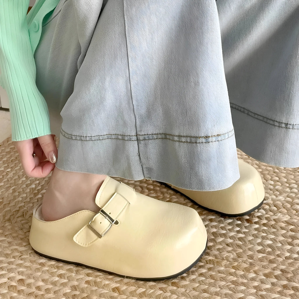 Flat buckle casual sneakers in yellow, creamy-white, silver, and black colours with round toe.
