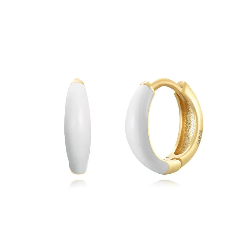A pair of glossy, U-shaped epoxy oval earrings with a round ring detail on silver copper posts.