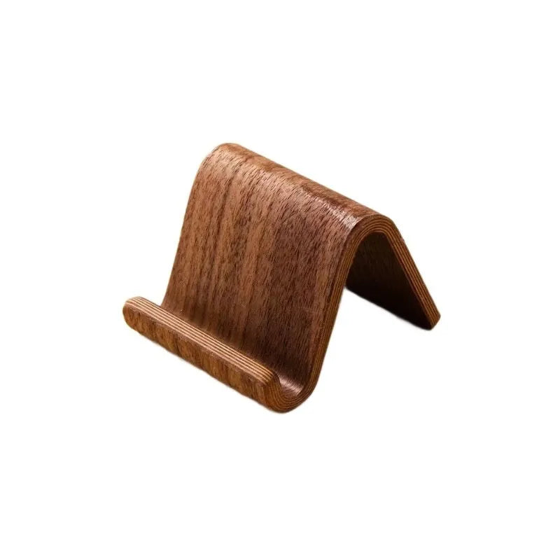 Walnut wood mobile phone bracket on a desk holding a smartphone upright for handsfree viewing