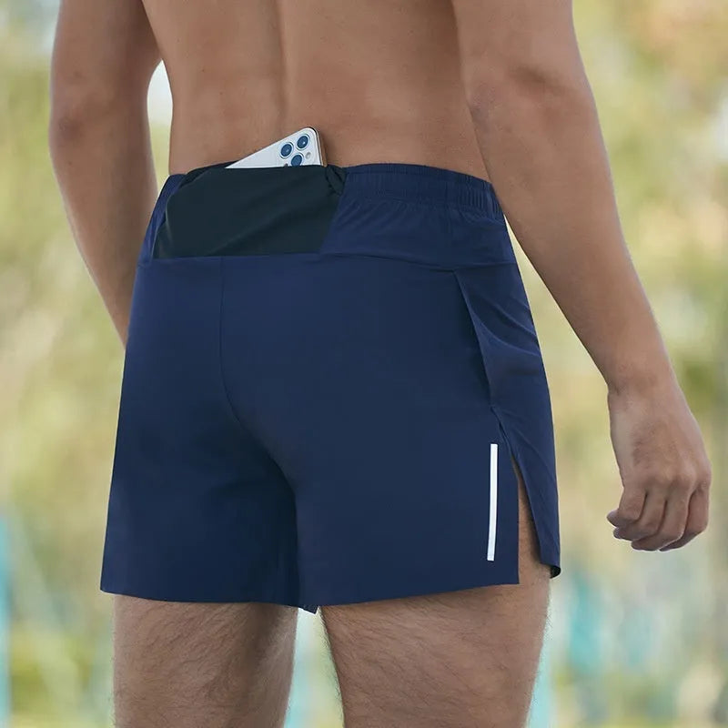 Men's loose-fit off-road running shorts in grey, showing high-waist design and built-in lining.