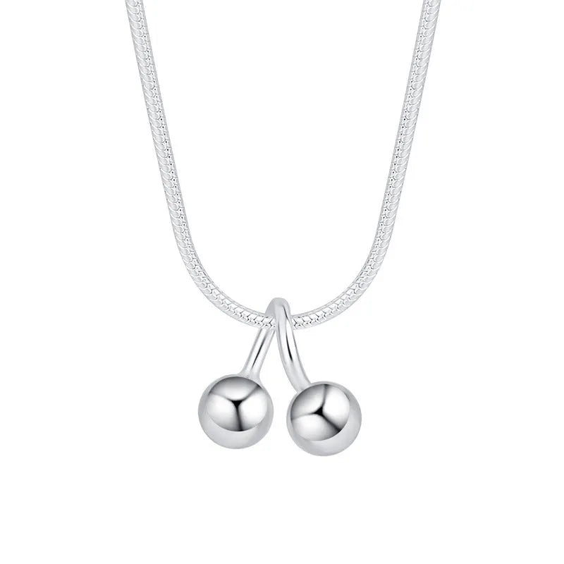 S925 sterling silver adjustable cherry pendant necklace with a snake bones chain on a white background.