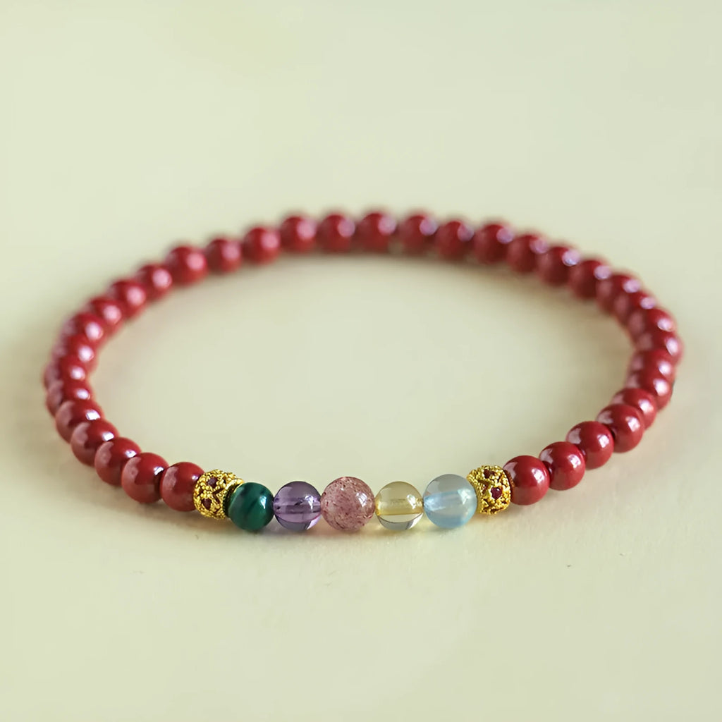 Purple gold cinnabar crystal bead bracelet on wrist showing handcrafted string construction