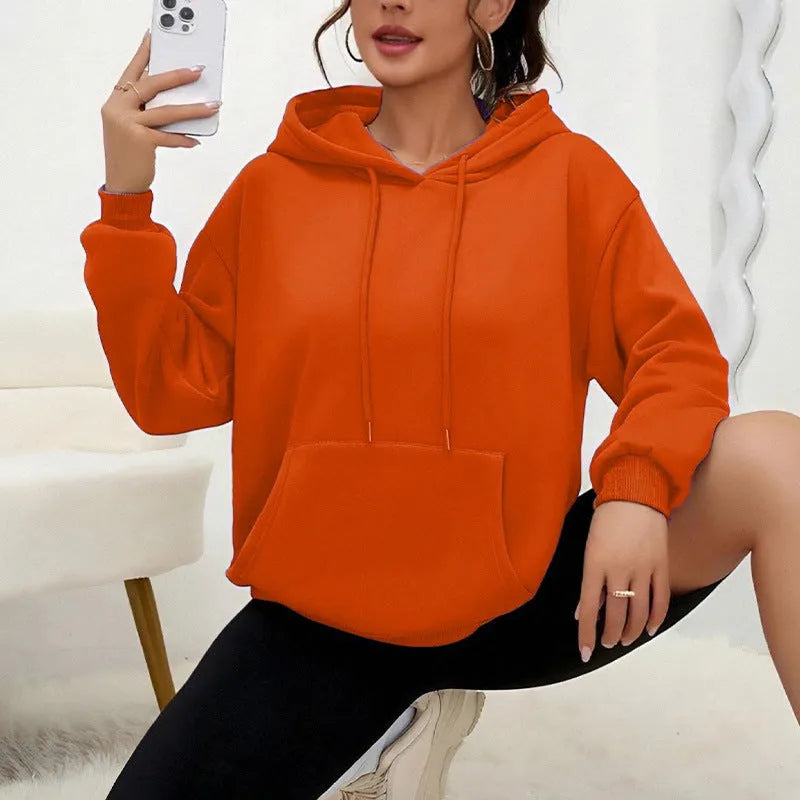 Women's loose grey hooded sweatshirt with a front pocket and drawstring.