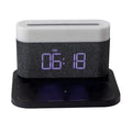 White and black bedside table lamp with wireless phone charging pad, digital clock display, and battery backup function