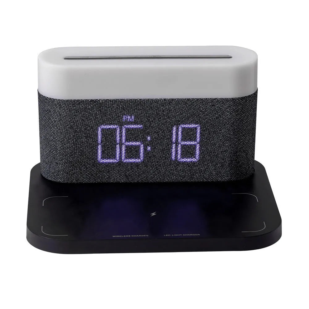 White and black bedside table lamp with wireless phone charging pad, digital clock display, and battery backup function
