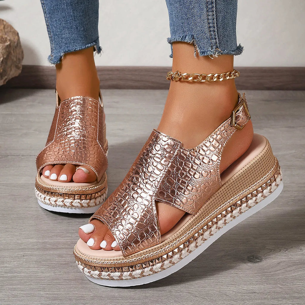 Gold women's Roman sandals with hollow-out design and an ankle buckle fastening.