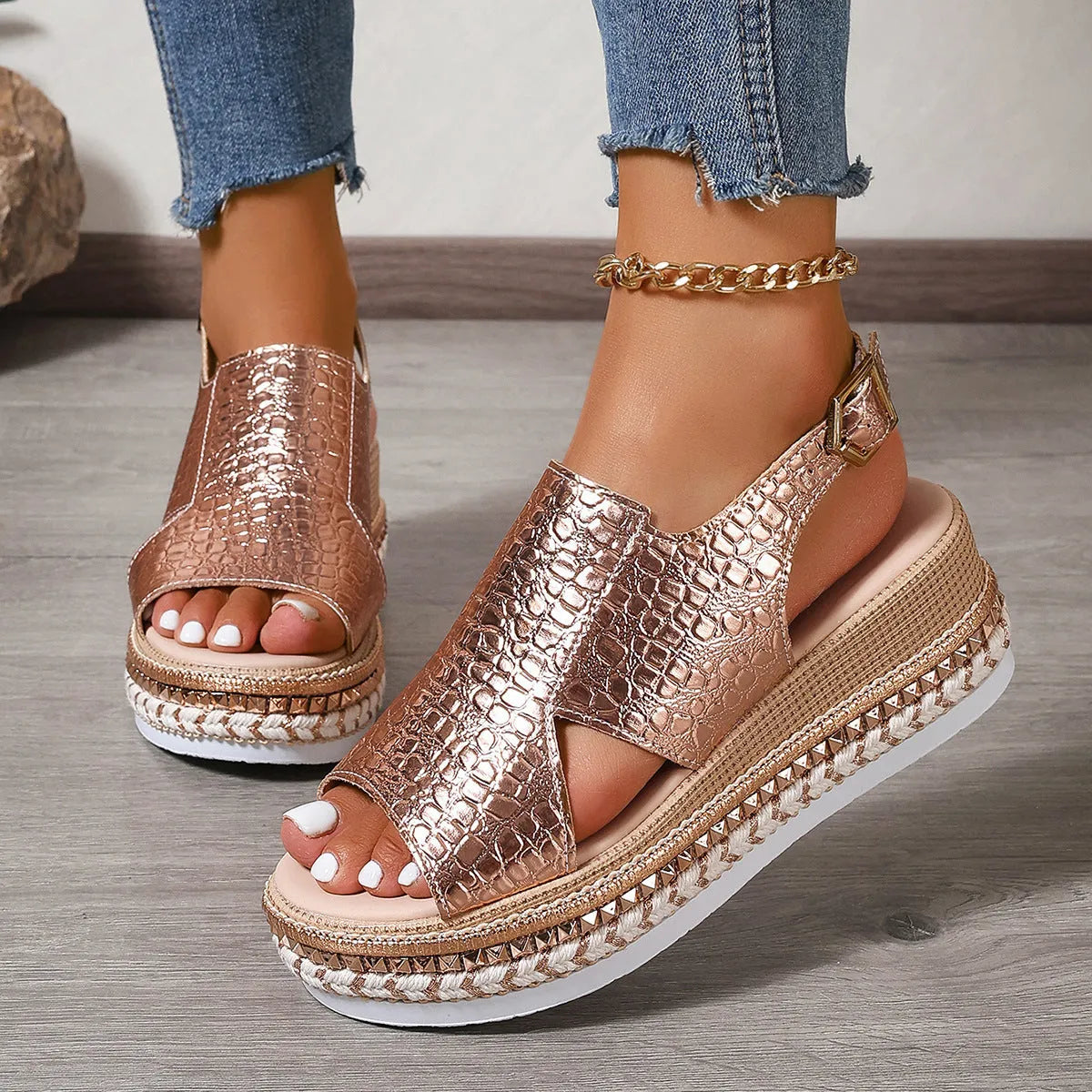 Gold women's Roman sandals with hollow-out design and an ankle buckle fastening.