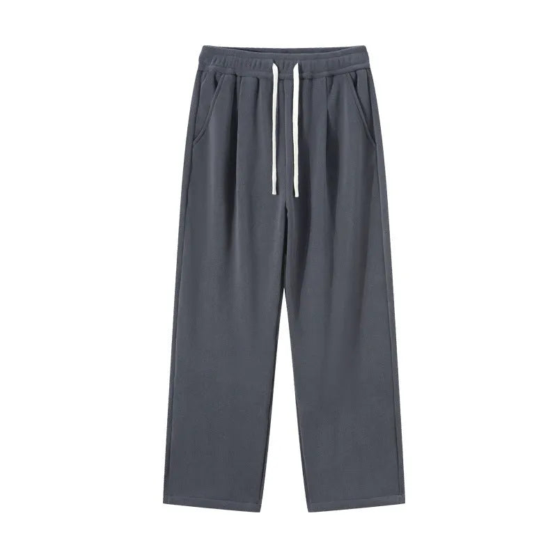 Men's apricot fleece-lined casual sports trousers with a loose fit and drawstring waist, laid flat.